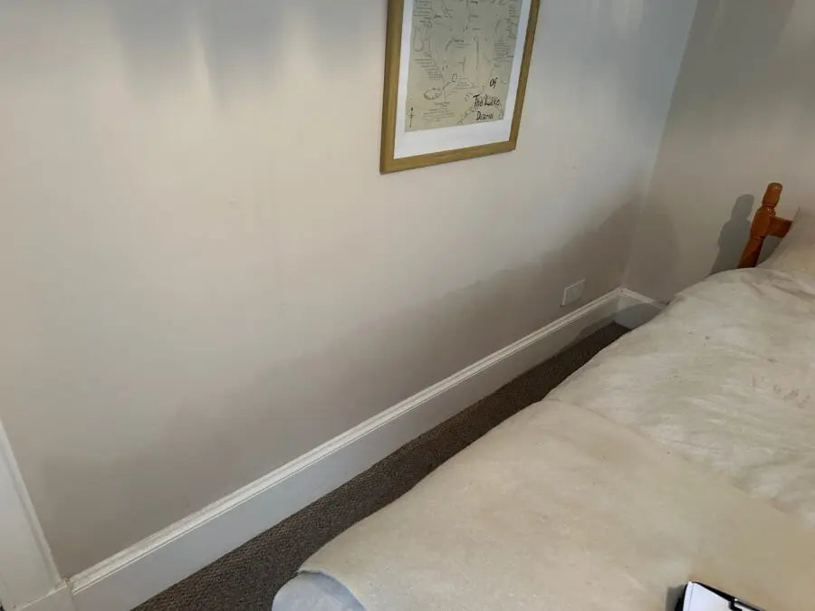 Bedroom corner with example of rising damp in households.