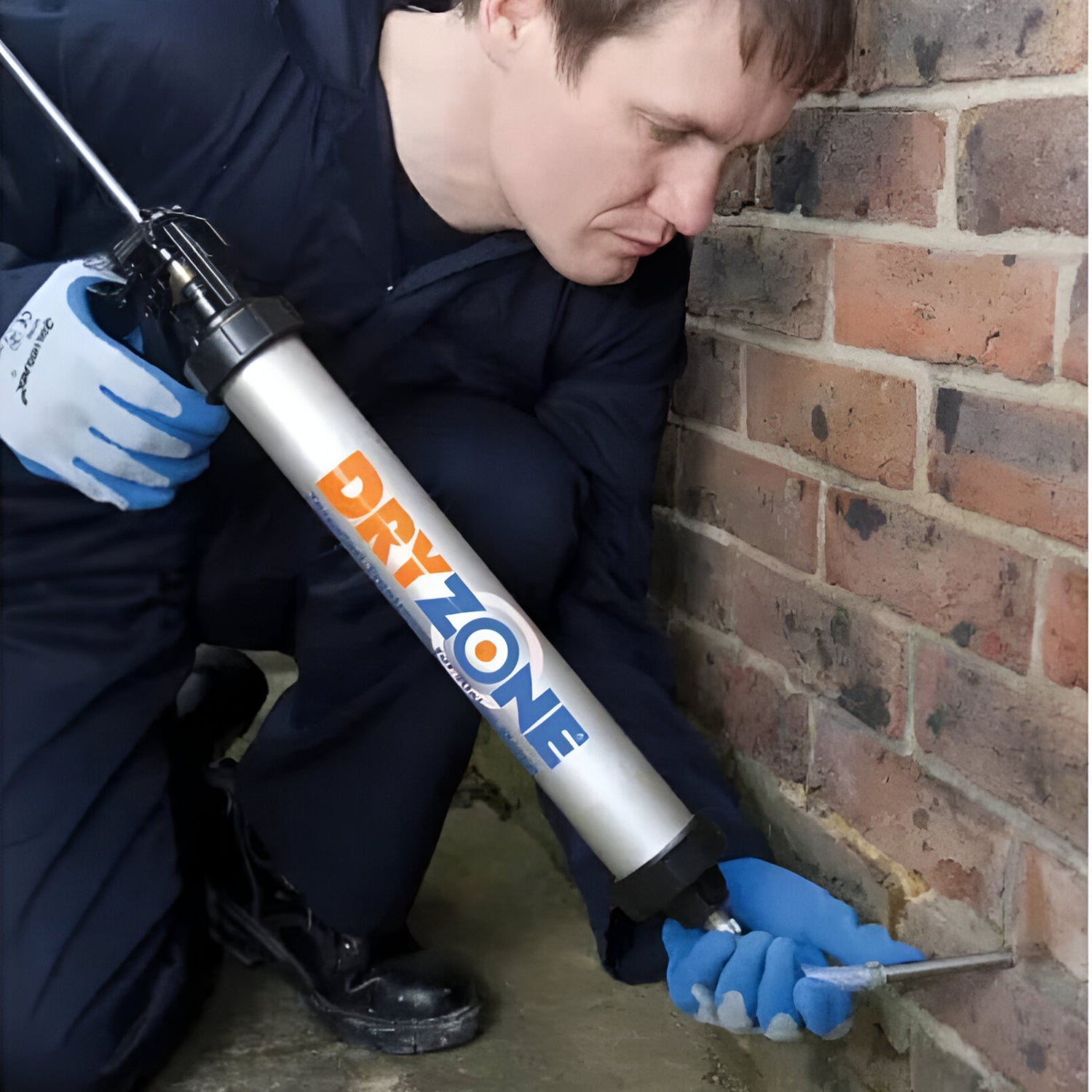 Injecting DRYZONE product to work on a brick wall.